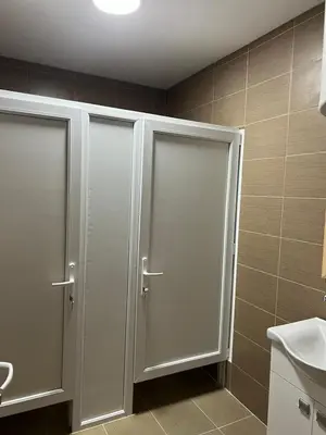 two sliding doors in a bathroom with a sink at Lokal za zurke, slavlja i rodjendane in Pećinci