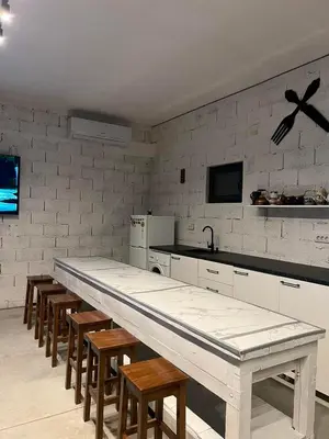 a kitchen with a long table and chairs in it at Lokal za zurke, slavlja i rodjendane in Pećinci