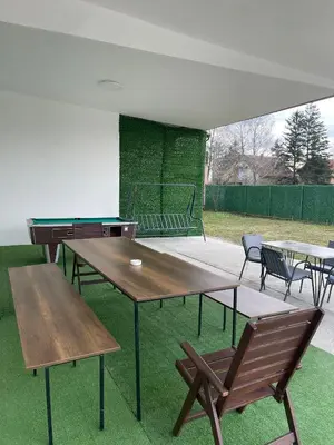 a group of tables and chairs with a ping pong table at Lokal za zurke, slavlja i rodjendane in Pećinci