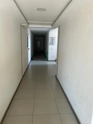 an empty hallway in an office building with white walls at Altina Gottfried Studio in Novi Grad