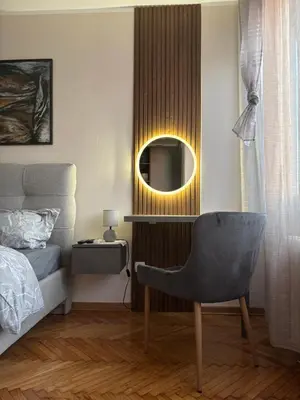 a bedroom with a chair and a mirror at Mina 2 in Belgrade