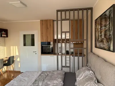 a living room with a bed and a kitchen at Mina 2 in Belgrade