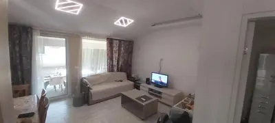 a living room with a couch and a television in it at Appartement Darvinova in Voždovac