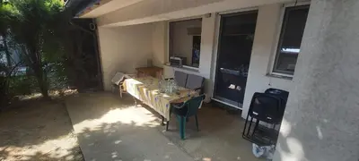 a table and chairs in front of a room with windows at Appartement Darvinova in Voždovac