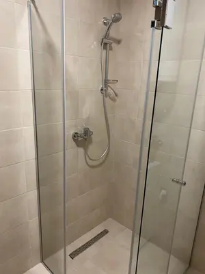 a shower stall with a glass shower door at Green Residence in Belgrade