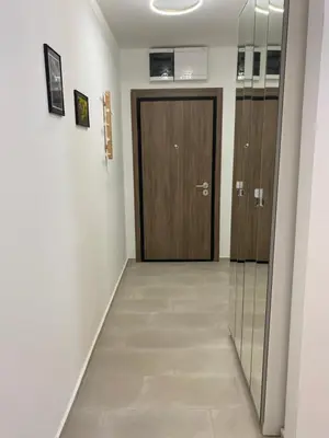 a hallway with a wooden door and a hallwayngth at Green Residence in Belgrade