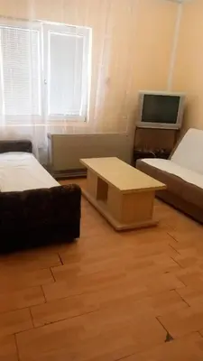 a room with two beds and a flat screen tv at Nina Lili in Mirijevo