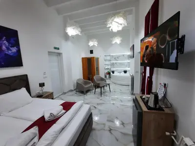 a bedroom with a bed and a room with a bathroom at Authentic Belgrade Centre - 3 Suites in One Space, with patios in courtyard for smokers in Belgrade