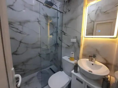 a bathroom with a toilet and a sink and a shower at Authentic Belgrade Centre - 3 Suites in One Space, with patios in courtyard for smokers in Belgrade