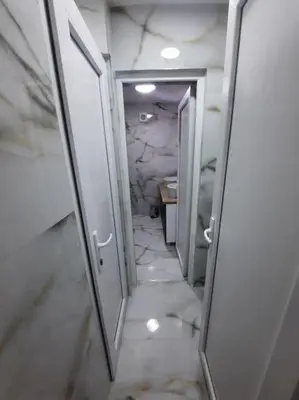 a hallway of a bathroom with a sink and a mirror at Authentic Belgrade Centre - 3 Suites in One Space, with patios in courtyard for smokers in Belgrade