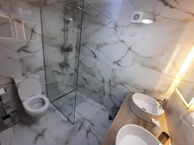 a bathroom with a toilet and a shower and a sink at Authentic Belgrade Centre - 3 Suites in One Space, with patios in courtyard for smokers in Belgrade
