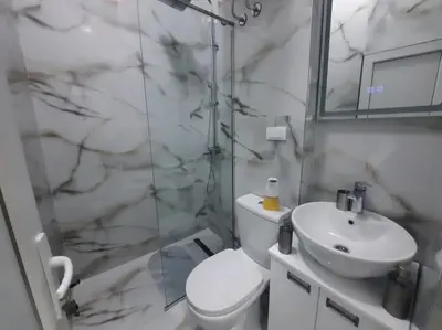 a bathroom with a toilet and a sink and a shower at Authentic Belgrade Centre - 3 Suites in One Space, with patios in courtyard for smokers in Belgrade