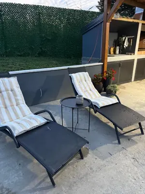two chairs and a table on a patio at Luxury house Nena Fruška gora - kuća za odmor in Velika Remeta