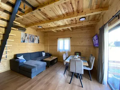 a living room with a couch and a table at Luxury house Nena Fruška gora - kuća za odmor in Velika Remeta