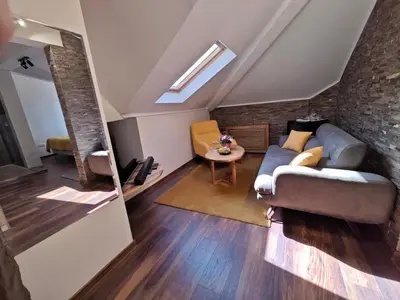 a living room with a couch and a table at Green Land Club in Novi Banovci