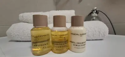 two bottles of essential oils sitting on a bathroom counter at Apartman Resavska in Belgrade