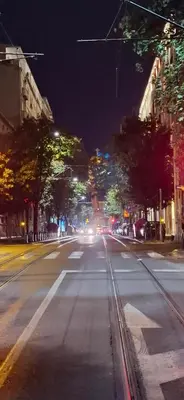 an empty city street at night with cars at Apartman Resavska in Belgrade