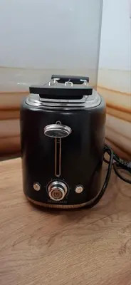 a black toaster sitting on top of a wooden floor at Apartman Resavska in Belgrade