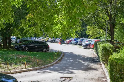 a street with cars parked in a parking lot at NAŠ Apartman in Voždovac
