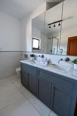 a bathroom with two sinks and a large mirror at Glamping Home in Bukovik