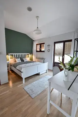 a bedroom with a large bed and a table at Glamping Home in Bukovik