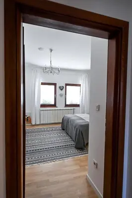 a view of a bedroom through a doorway at Glamping Home in Bukovik