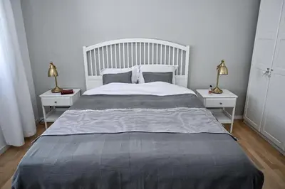 a bedroom with a large bed with two night stands at Glamping Home in Bukovik