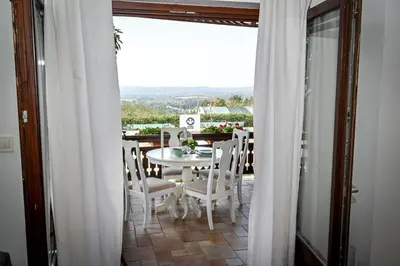 a table and chairs on a balcony with a view at Glamping Home in Bukovik