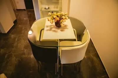 a glass table with a vase of flowers on it at Lina Apartments in Belgrade