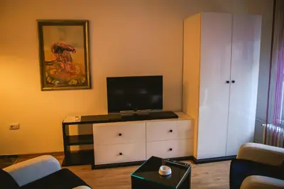 a living room with a tv on top of a dresser at Lina Apartments in Belgrade