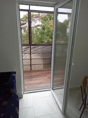 a sliding glass door with a view of a balcony at Beograd, Oaza Palilula, 2 in Borča