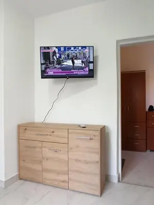 a flat screen tv hanging on a wall at Beograd, Oaza Palilula, 2 in Borča