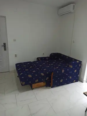 a bedroom with a bed with a blue comforter at Beograd, Oaza Palilula, 2 in Borča