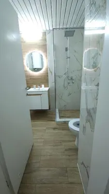 a bathroom with a shower and a toilet and a sink at Nele in Bežanija