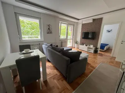 a living room with a couch and a table at Nele in Bežanija