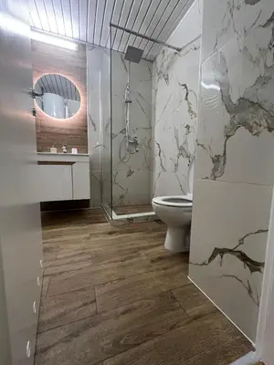 a bathroom with a toilet and a shower and a mirror at Nele in Bežanija