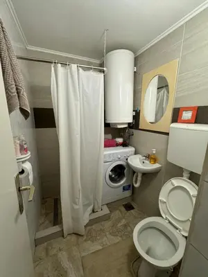 a small bathroom with a toilet and a sink at Jakovljević Apartment in Belgrade