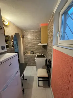 a small kitchen with a table and a sink at Jakovljević Apartment in Belgrade