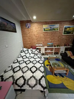 a bedroom with a bed and a living room at Jakovljević Apartment in Belgrade