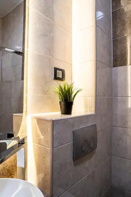 a bathroom with a sink and a plant on a shelf at Apartman ISKRA - Velvet in Arandjelovac