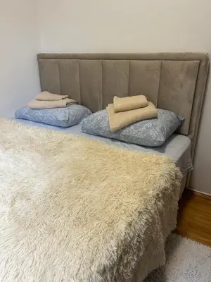 a bed with two pillows on top of it at Dream apartmen in Novi Grad