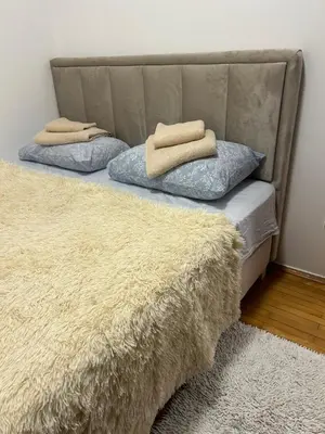 two pillows sitting on top of a bed at Dream apartmen in Novi Grad