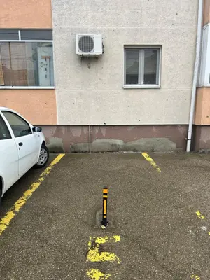 a white car parked in a parking lot next to a building at Dream apartmen in Novi Grad