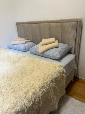 a bed with two pillows on top of it at Dream apartmen in Novi Grad