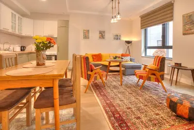a kitchen and living room with a table and chairs at Peaceful Downtown Home in Vračar (historical)
