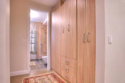 a bathroom with wooden cabinets and a toilet at Peaceful Downtown Home in Vračar (historical)