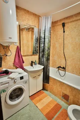 a bathroom with a washing machine and a sink at Malisic apartmani Vračar in Vračar (historical)
