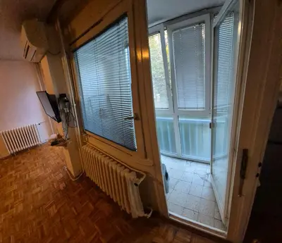 a room with a large window with blinds on it at Blok 1 in Belgrade