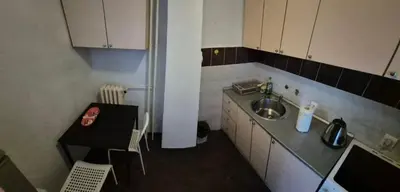 a small kitchen with a sink and a table at Blok 1 in Belgrade