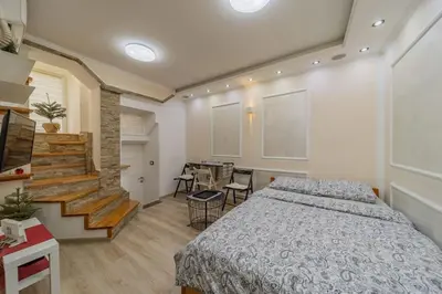 a bedroom with a bed and a table and chairs at Megi Zemun Apartment in Zemun
